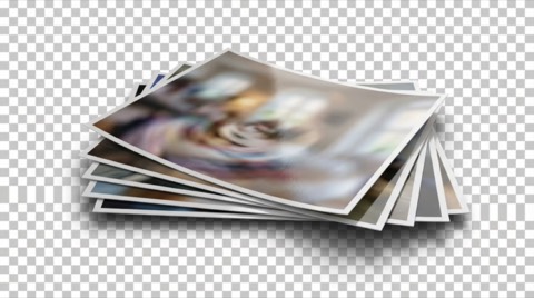 Stack of glossy printed photos with blurred colorful images and reflective surfaces on transparent background close up